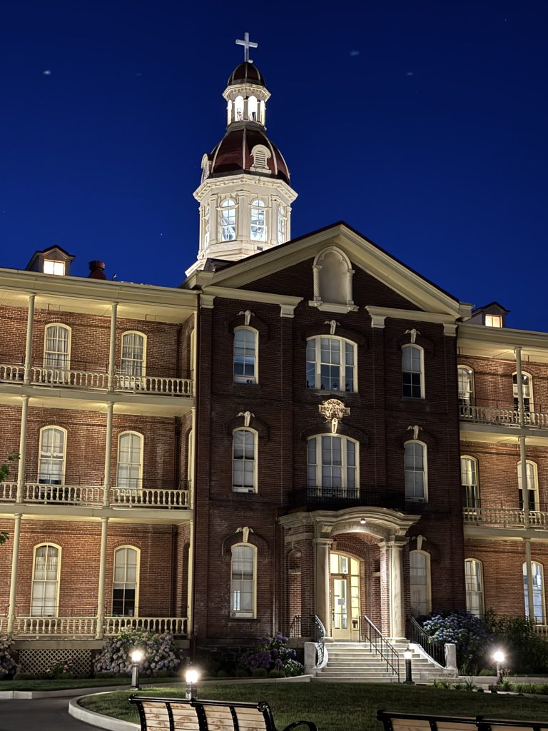 Providence Academy front entry and cupola at night with exterior illumination